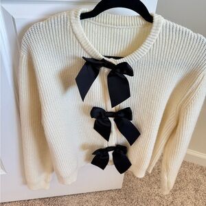 Elegant Cream Sweater with Black Bow Accents